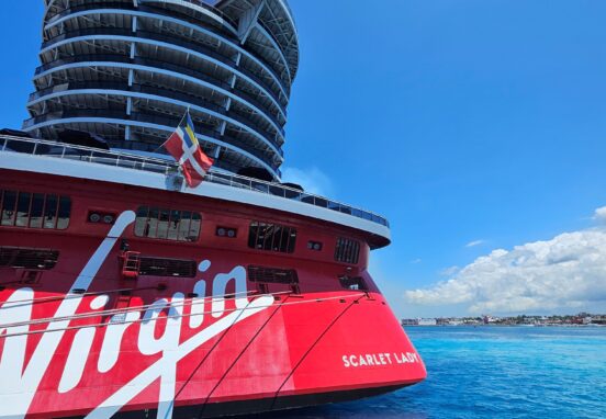 scarlet lady cruise ship docked at the port in cozumel shows virgin voyages signage and scarlet lady ship name